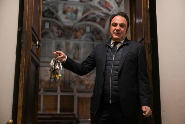 Gianni Crea, key keeper of the Vatican Museums, holds one of the mast of keys at the entrance of the Sistine Chapel from the museums during a private visit by night, early on February 13, 2024. — AFP pic